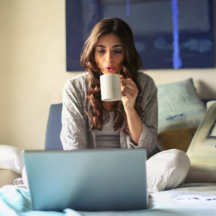 looking at computer with coffee