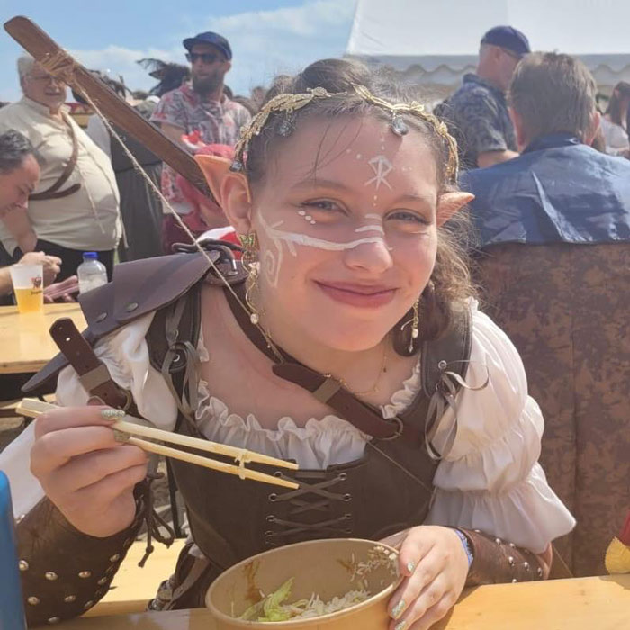 Girl cosplaying as elf and eating lunch